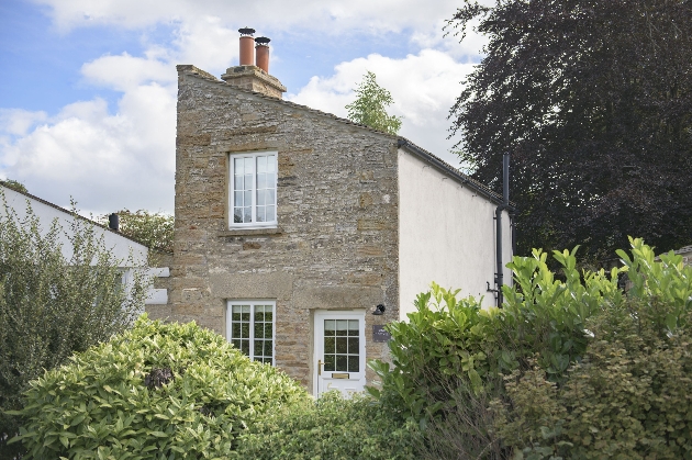 grey stone cottage with angled roof