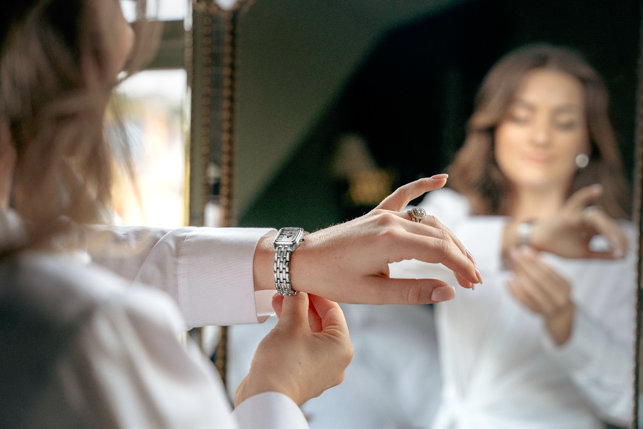  Monica Marriott-Mills putting on watch in front of mirror