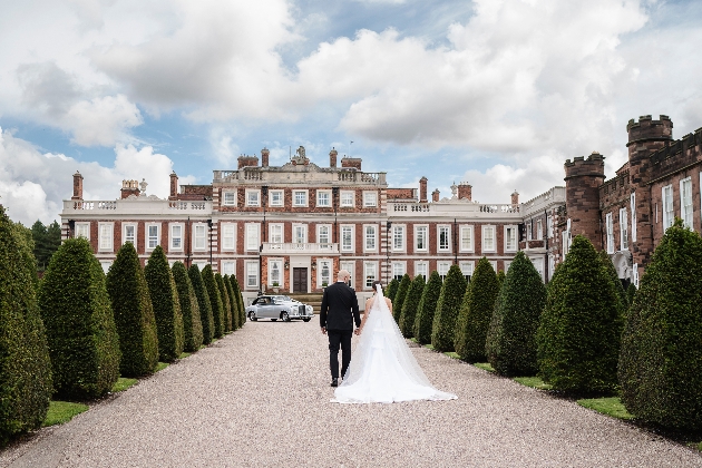 Knowsley Hall with bride and groom walking towards it