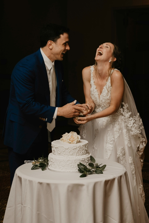 bride and groom cutting cake